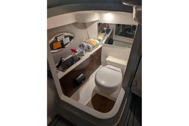 Slide: The Image of 2024 Chaparral 267 SSX boat bathroom with sink, toilet, and storage. - 20