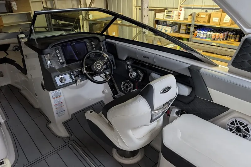 Slide: The Image of 2024 Chaparral 267 SSX boat interior with modern dashboard and steering wheel. - 22