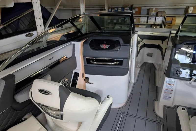 Slide: The Image of 2024 Chaparral 267 SSX boat interior with modern seating and dashboard controls. - 23