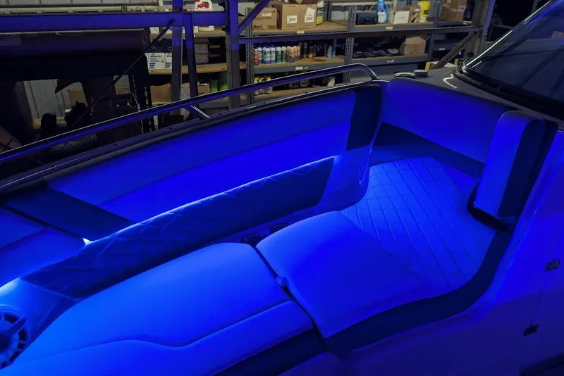 Slide: The Image of 2024 Chaparral 267 SSX boat interior with blue LED lighting. - 39