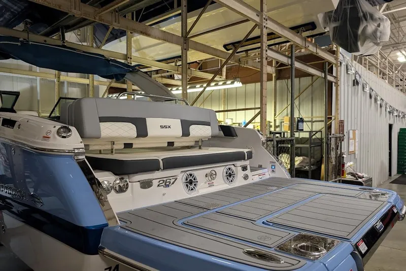 Slide: The Image of 2024 Chaparral 267 SSX boat in a warehouse, showcasing sleek design and modern features. - 6