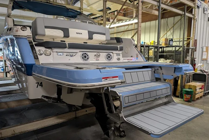 Slide: The Image of 2024 Chaparral 267 SSX boat with extended swim platform in a workshop setting. - 8