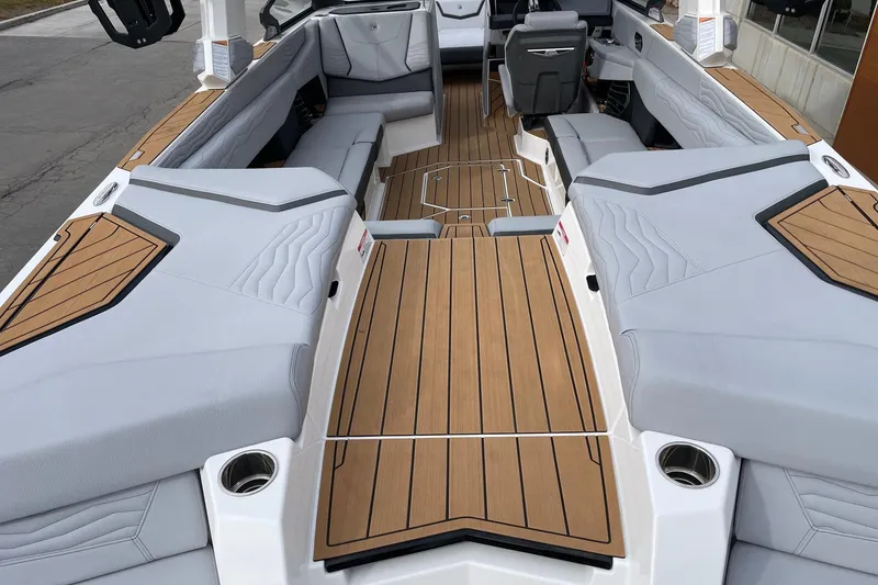 Slide: The Image of 2025 Nautique Super Air Nautique G25 interior with sleek seating and wood accents. - 4