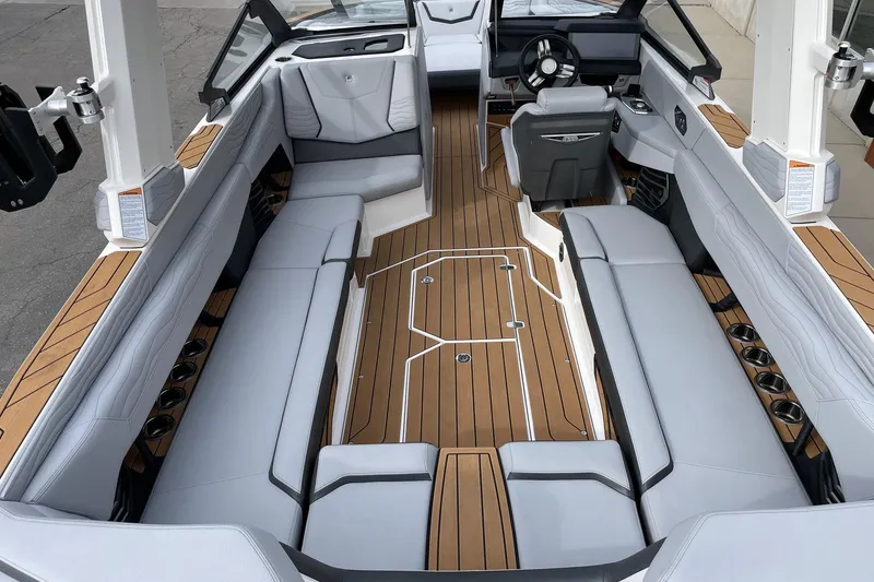 Slide: The Image of 2025 Nautique Super Air Nautique G25 interior with luxurious seating and sleek design. - 5