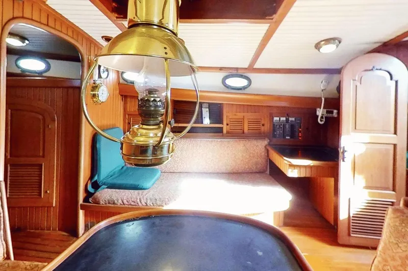 Slide: The Image of Interior of 1985 Hans Christian 38 sailboat with vintage lamp and wooden furnishings. - 13