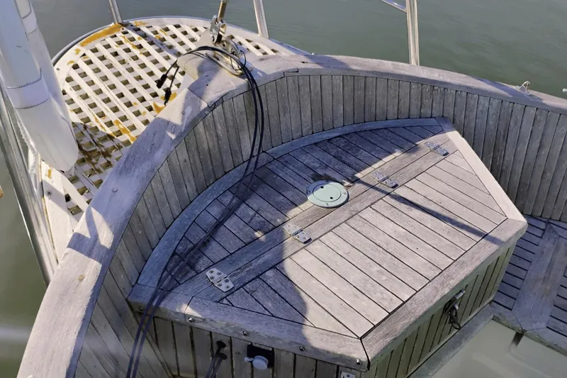 Slide: The Image of Wooden deck of 1985 Hans Christian 38 sailboat with storage compartment and cables. - 6