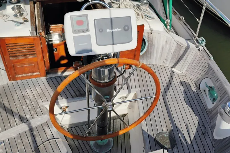 Slide: The Image of Cockpit of 1985 Hans Christian 38 sailboat with wooden wheel and navigation equipment. - 7