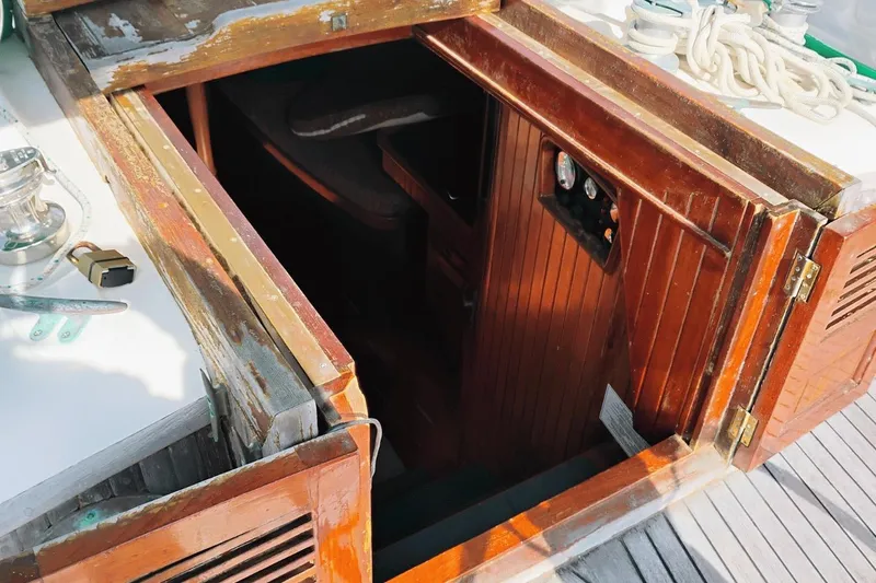 Slide: The Image of Open hatch of 1985 Hans Christian 38 sailboat, showing wooden interior and nautical equipment. - 8