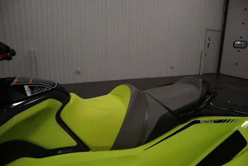 Slide: The Image of 2018 Sea-Doo RXT-X 300 jet ski with vibrant yellow seat in a garage setting. - 17