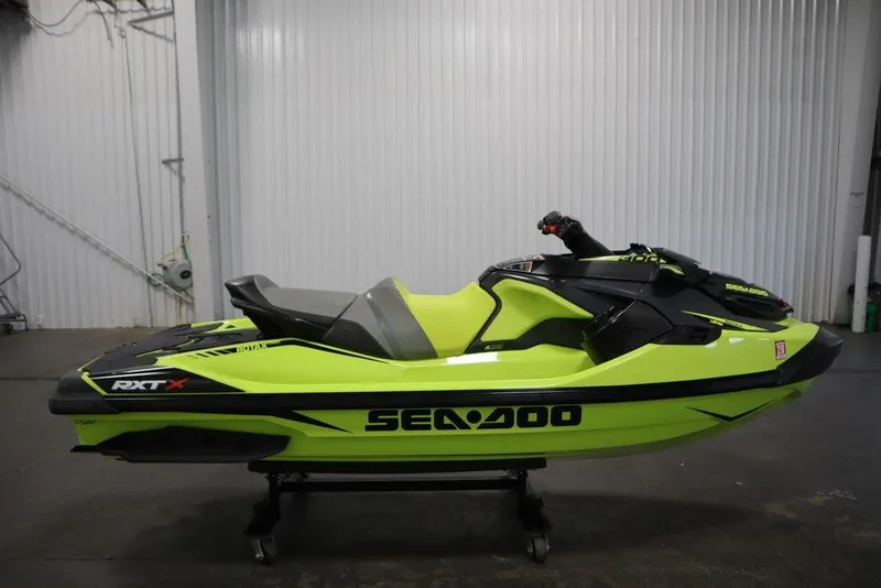 Slide: The Image of 2018 Sea-Doo RXT-X 300 jet ski in vibrant lime green, side view. - 3