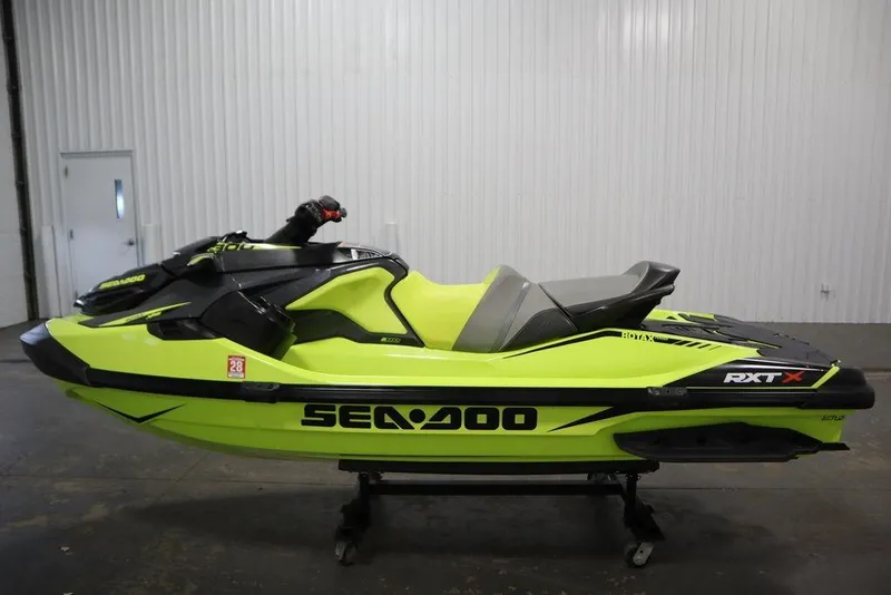 Slide: The Image of 2018 Sea-Doo RXT-X 300 jet ski in vibrant yellow, side view in a garage. - 6