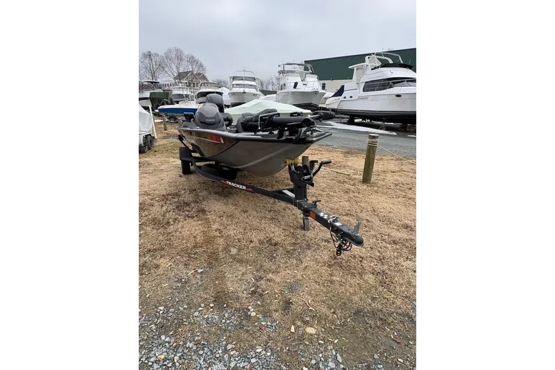 Slide: The Image of 2023 Tracker Pro Team 175 TXW boat on trailer, parked outdoors near other boats. - 4