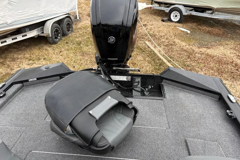 Slide: The Image of 2023 Tracker Pro Team 175 TXW boat interior with motor and seating. - 6