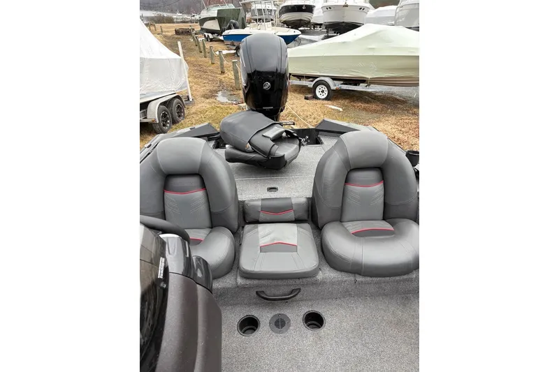 Slide: The Image of 2023 Tracker Pro Team 175 TXW boat interior with gray seating and motor. - 7