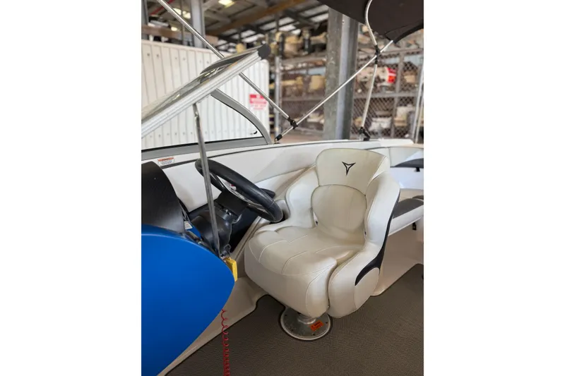 Slide: The Image of Interior of 2021 Campion Chase 20 boat featuring a white captain's seat and steering wheel. - 10