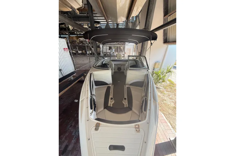 Slide: The Image of 2021 Campion Chase 20 boat with sleek interior and canopy, docked in a storage area. - 3