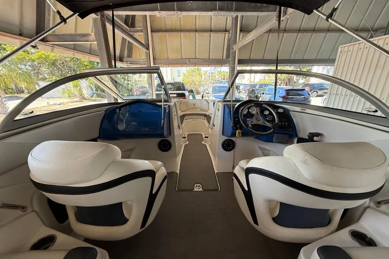 Slide: The Image of Interior of a 2021 Campion Chase 20 boat with white seating and modern dashboard. - 5
