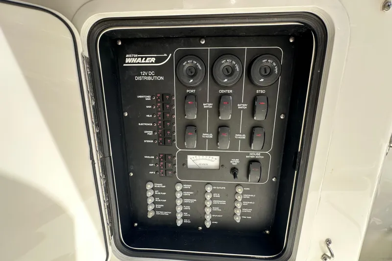 Slide: The Image of Control panel of a 2018 Boston Whaler 350 Outrage boat, showing 12V DC distribution. - 12