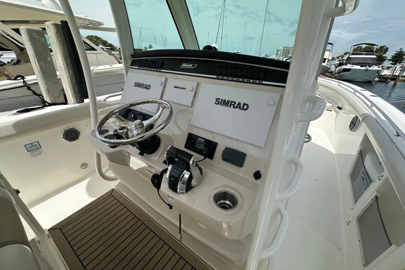 Slide: The Image of 2018 Boston Whaler 350 Outrage helm with Simrad electronics and Mercury controls. - 14