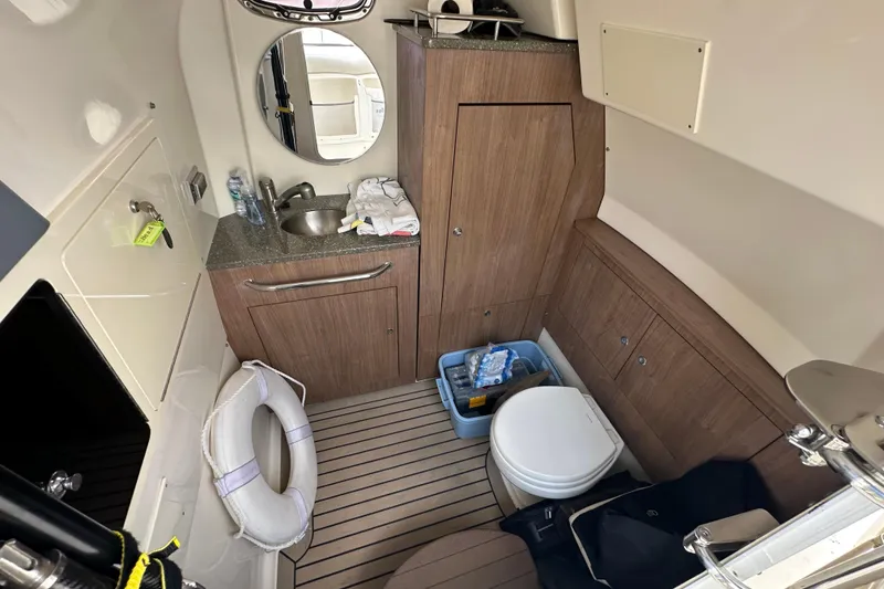 Slide: The Image of Interior of 2018 Boston Whaler 350 Outrage boat with sink, toilet, and storage. - 15