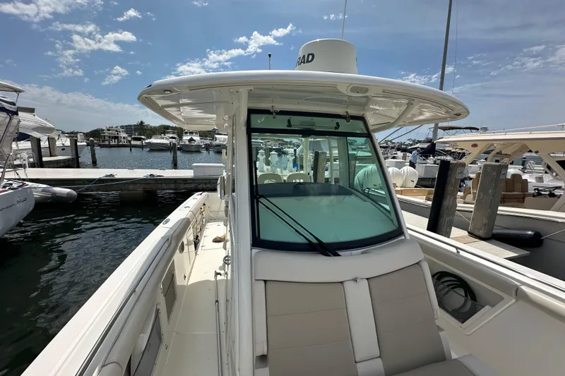 Slide: The Image of 2018 Boston Whaler 350 Outrage docked at marina under clear blue sky. - 21