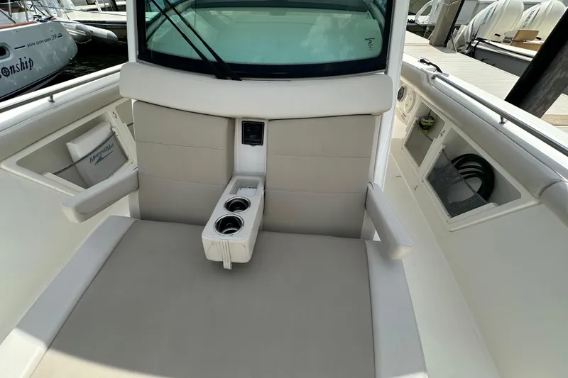 Slide: The Image of 2018 Boston Whaler 350 Outrage interior with seating and cup holders. - 22