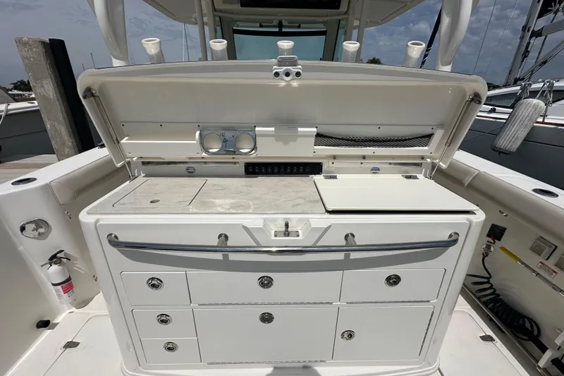 Slide: The Image of 2018 Boston Whaler 350 Outrage boat cockpit with storage and utility area. - 28