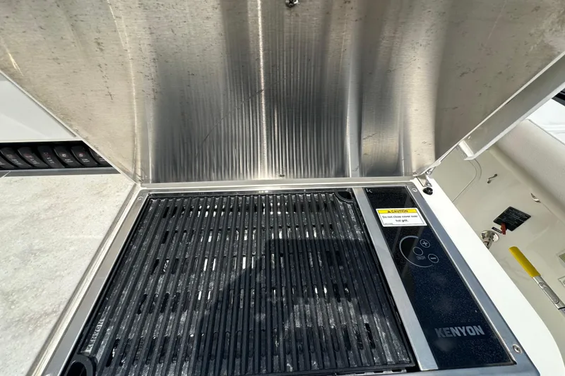 Slide: The Image of Kenyon grill on 2018 Boston Whaler 350 Outrage boat, stainless steel cover open. - 29