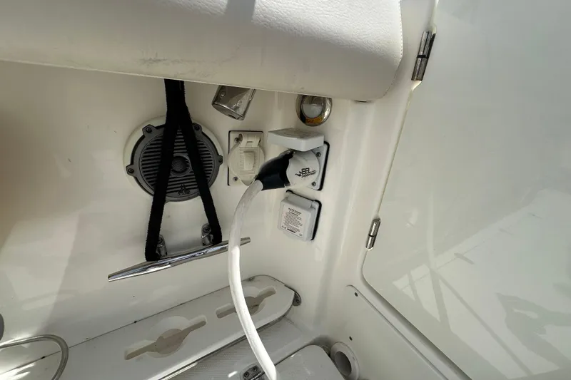 Slide: The Image of 2018 Boston Whaler 350 Outrage boat interior with power outlet and speaker. - 34