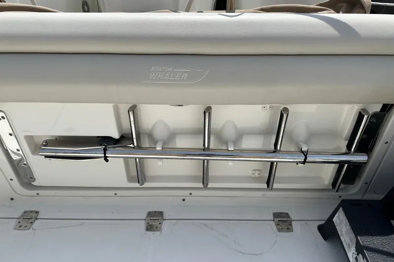 Slide: The Image of 2018 Boston Whaler 350 Outrage boat interior with rod holders and seating. - 36