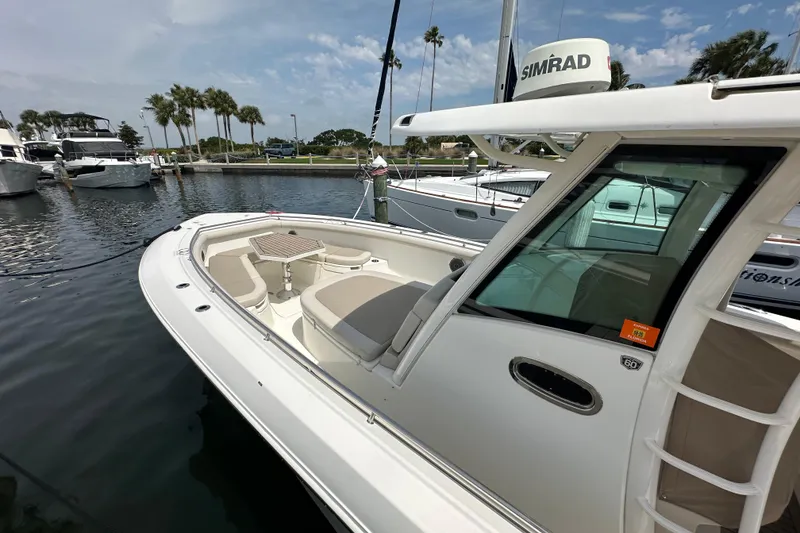 Slide: The Image of 2018 Boston Whaler 350 Outrage docked, featuring spacious seating and modern design. - 38