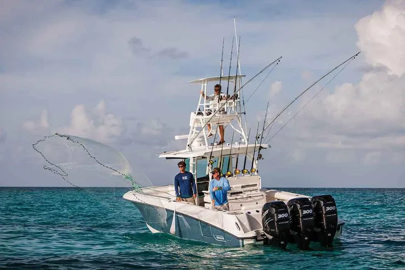 Slide: The Image of Manufacturer Provided Image: 2018 Boston Whaler 350 Outrage fishing boat with triple engines in open water. - 5