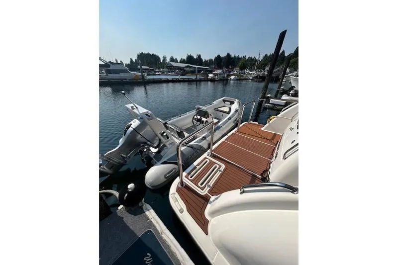 Slide: The Image of 2008 Tiara Yachts 3900 Sovran docked with tender boat, sunny marina view. - 13