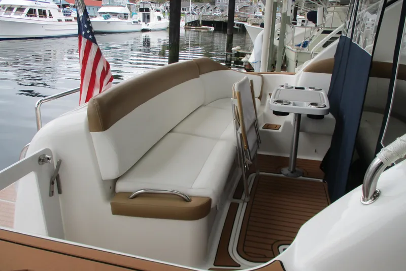 Slide: The Image of 2008 Tiara Yachts 3900 Sovran interior with seating and table, docked at marina. - 19