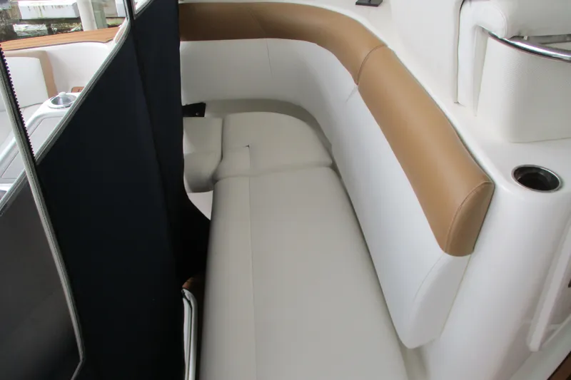 Slide: The Image of Luxurious seating area on a 2008 Tiara Yachts 3900 Sovran, featuring white and tan upholstery. - 20