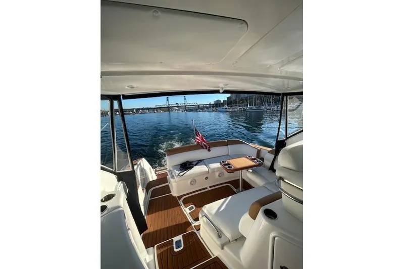 Slide: The Image of 2008 Tiara Yachts 3900 Sovran interior with seating, table, and marina view. - 21