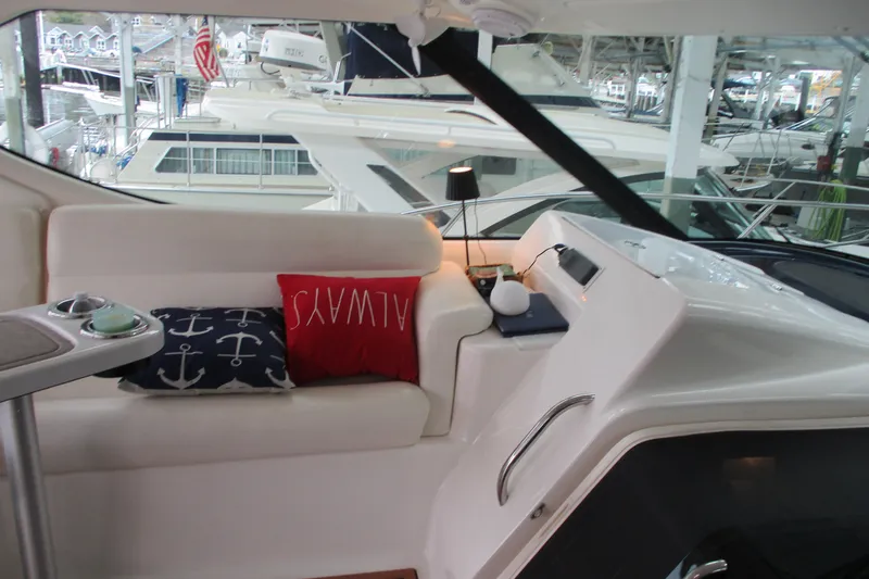 Slide: The Image of Interior of 2008 Tiara Yachts 3900 Sovran with nautical-themed cushions and sleek seating. - 24