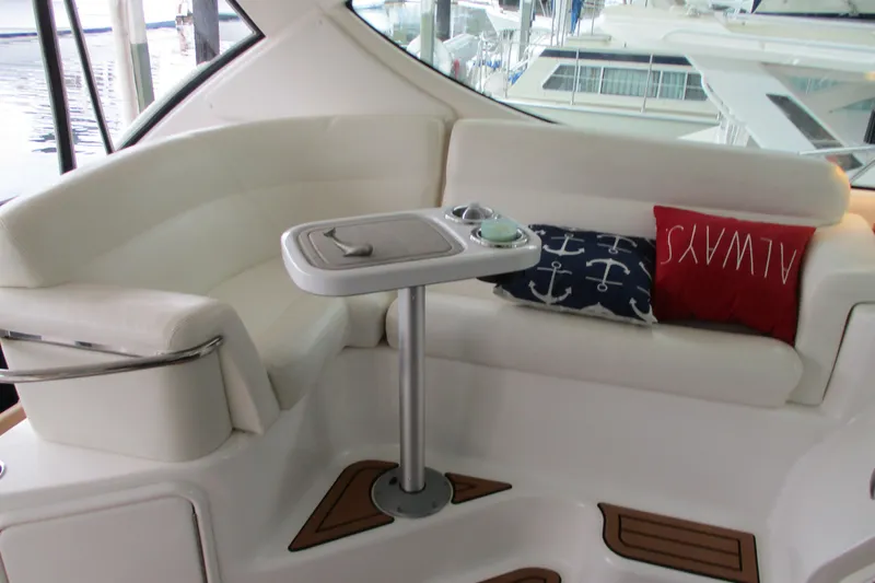 Slide: The Image of 2008 Tiara Yachts 3900 Sovran interior with white seating and nautical-themed pillows. - 26