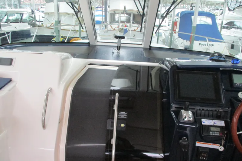 Slide: The Image of 2008 Tiara Yachts 3900 Sovran helm with navigation equipment and marina view. - 27
