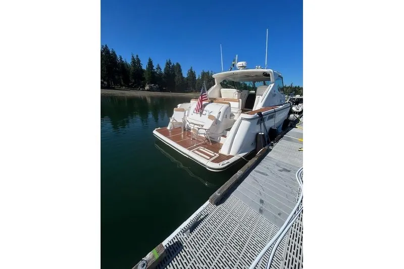 Slide: The Image of 2008 Tiara Yachts 3900 Sovran docked on a sunny day with American flag. - 3