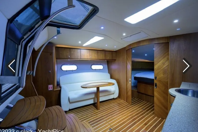 Slide: The Image of Luxurious interior of 2008 Tiara Yachts 3900 Sovran with wood accents and seating area. - 30