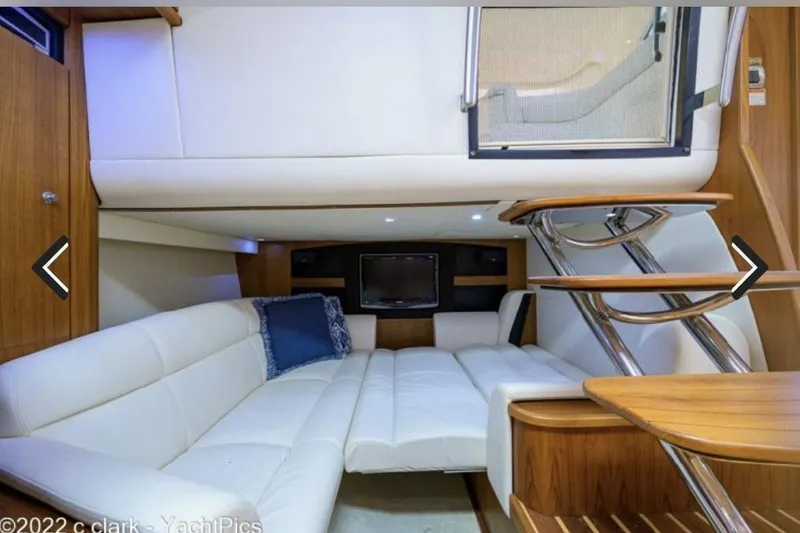 Slide: The Image of Luxurious interior of 2008 Tiara Yachts 3900 Sovran with white seating and wooden accents. - 32