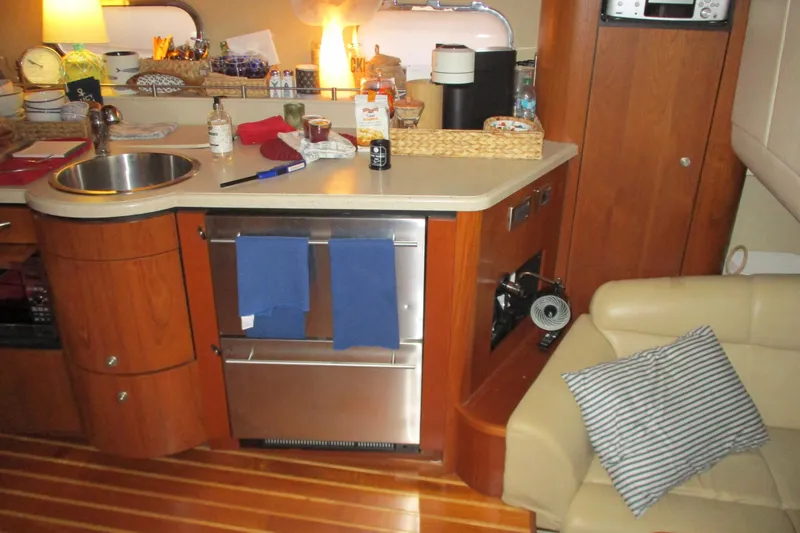 Slide: The Image of 2008 Tiara Yachts 3900 Sovran interior with kitchenette, sink, and seating area. - 35