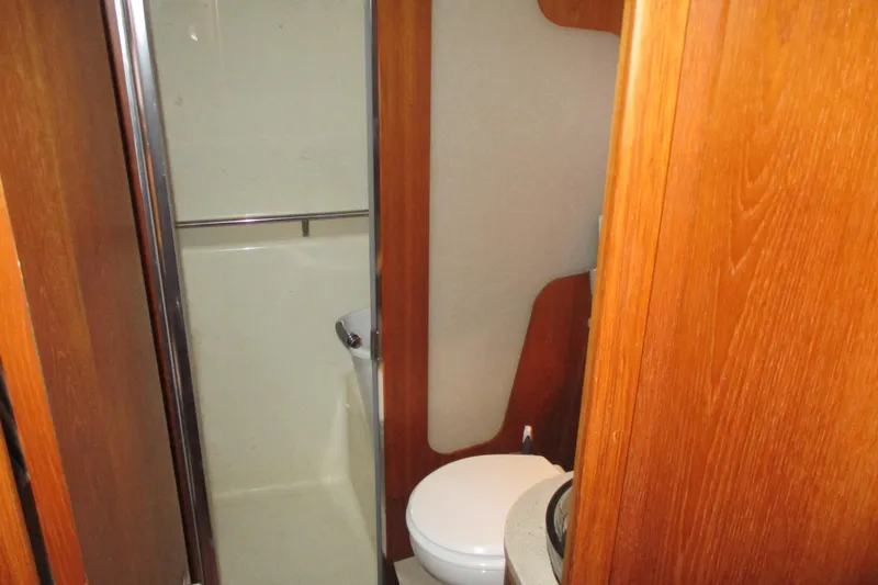 Slide: The Image of 2008 Tiara Yachts 3900 Sovran bathroom with wooden cabinetry and compact design. - 36