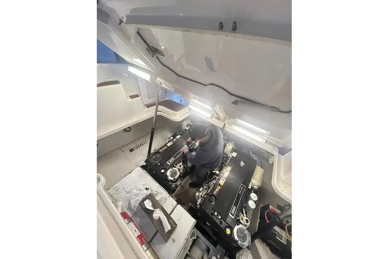 Slide: The Image of Mechanic working on 2008 Tiara Yachts 3900 Sovran engine in well-lit compartment. - 43