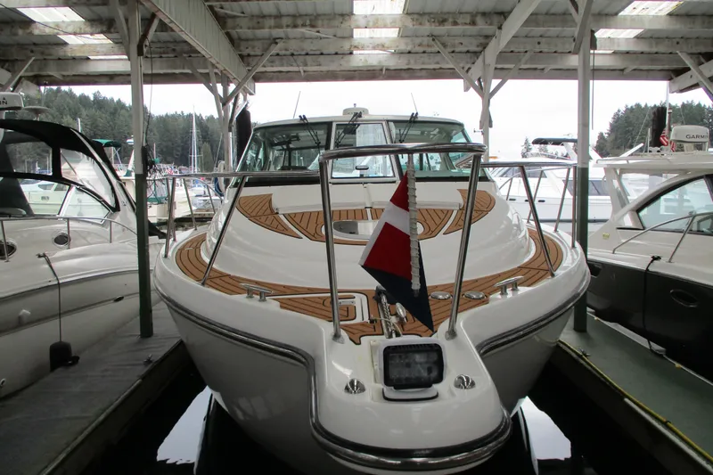 Slide: The Image of 2008 Tiara Yachts 3900 Sovran docked under a covered marina, showcasing sleek design. - 5