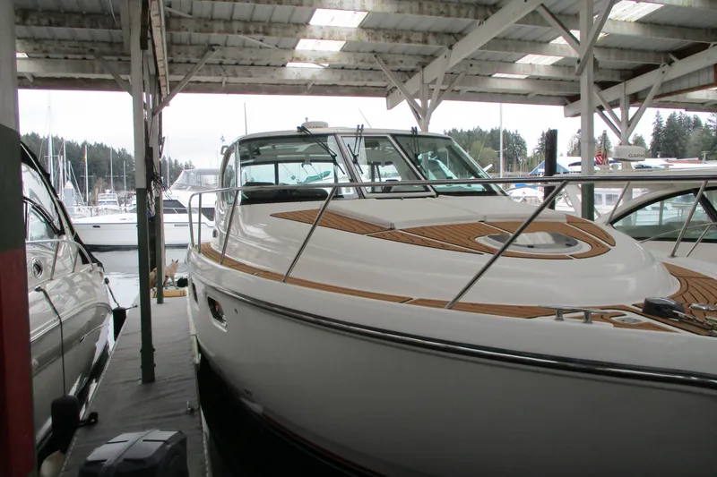 Slide: The Image of 2008 Tiara Yachts 3900 Sovran docked under a covered marina. - 8