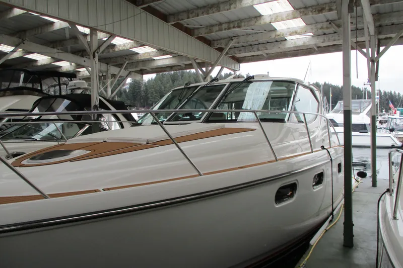 Slide: The Image of 2008 Tiara Yachts 3900 Sovran docked under a covered marina. - 9