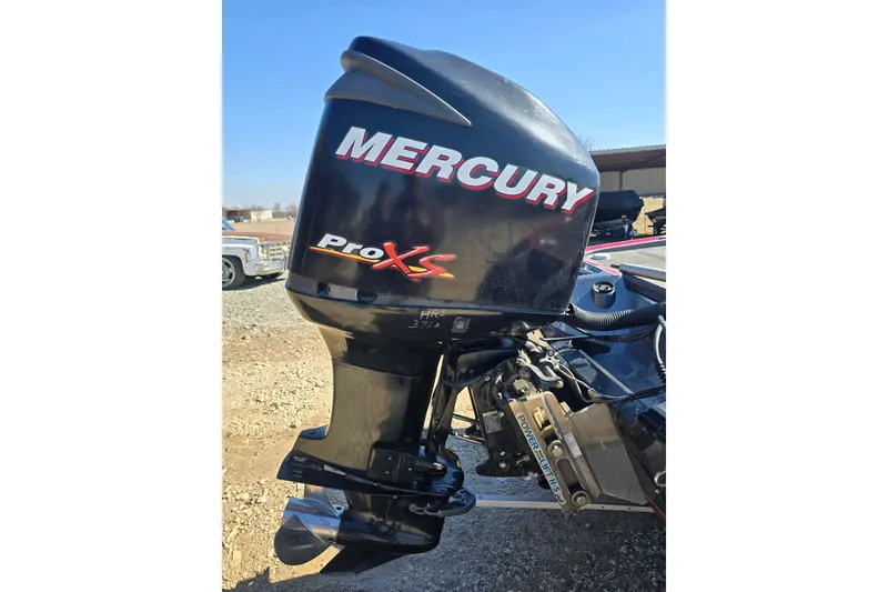 Slide: The Image of 2009 Triton 20X3 Pro DC with Mercury Pro XS outboard motor, parked outdoors. - 12