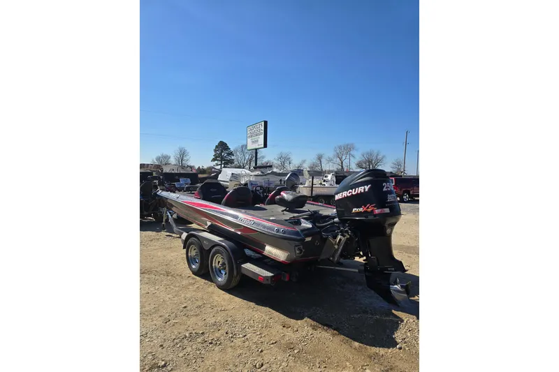 Slide: The Image of 2009 Triton 20X3 Pro DC boat with Mercury engine on trailer, parked outdoors. - 5